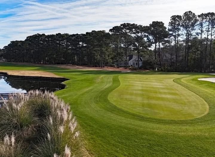 A golf course fairway beside the water